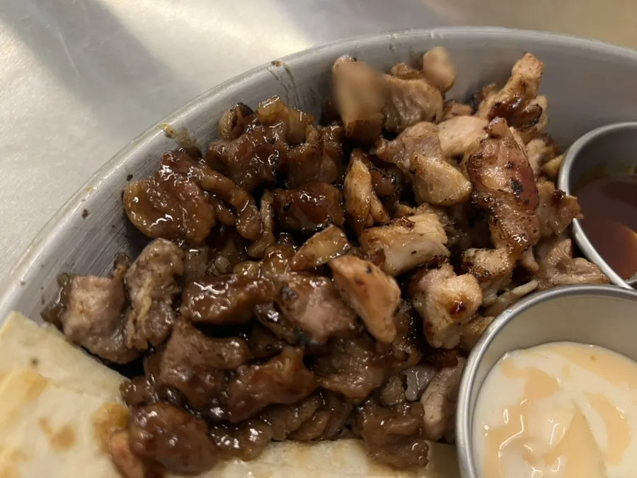 Beef ribs and seasoned chicken thigh together on the platter