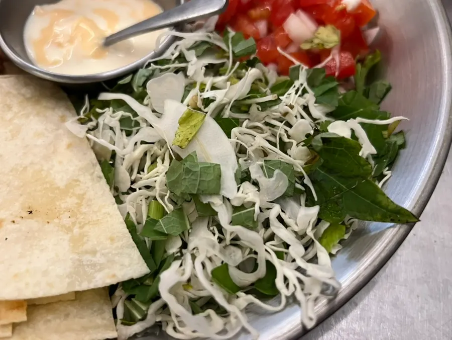 A bite of meat piled on top of the tortilla