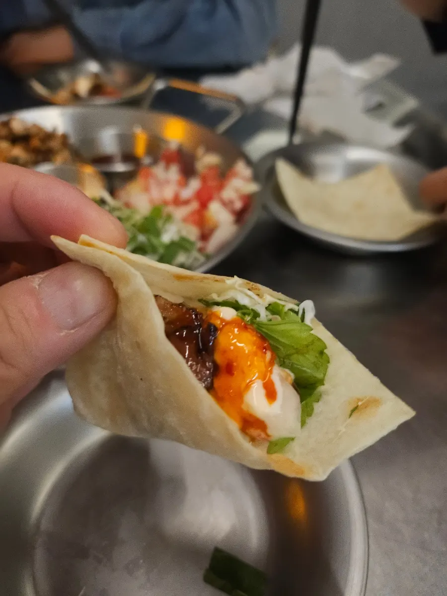 A taco wrapped in a crispy-edged tortilla