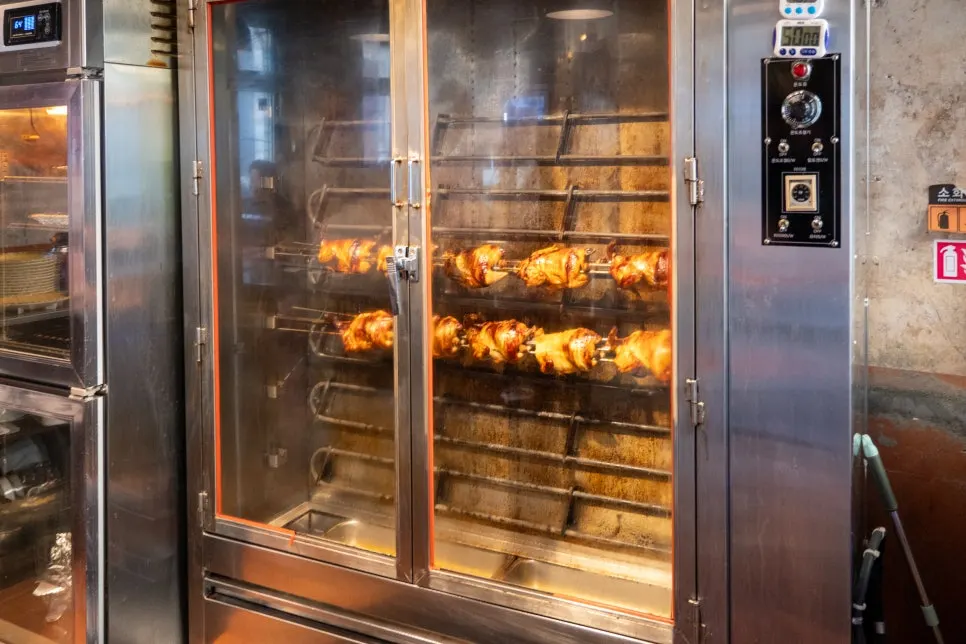 Rotisserie chicken roasting near the entrance