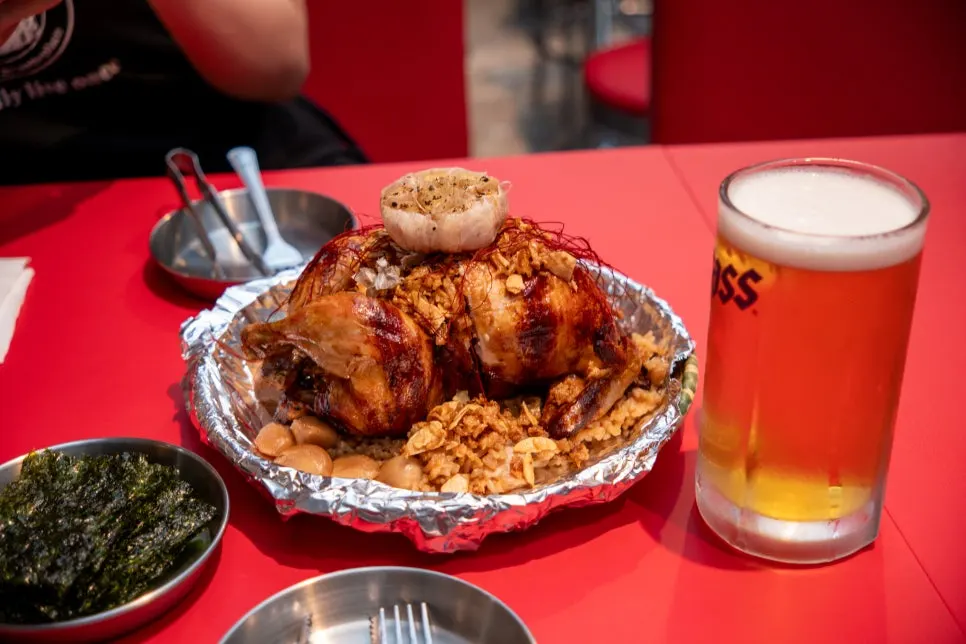 A whole golden rotisserie chicken served on the table