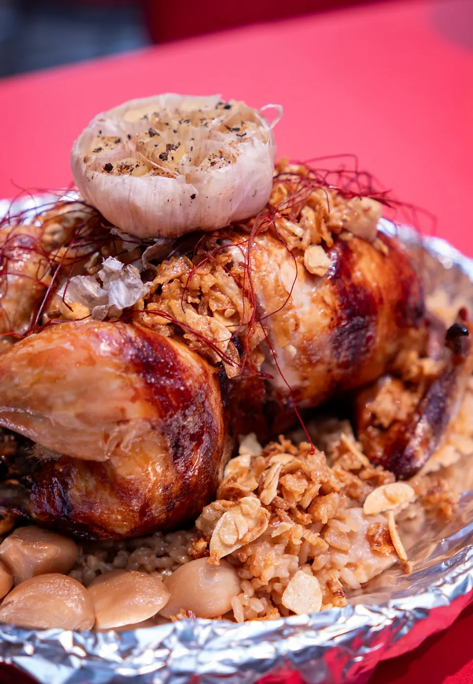 Golden chicken served with whole garlic cloves and garlic chips