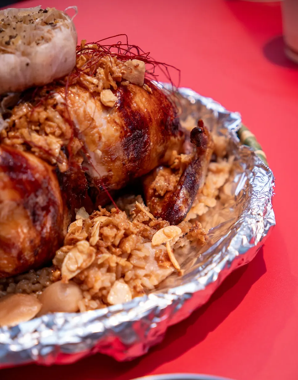 Close-up of the golden chicken plate over a bed of garlic chips