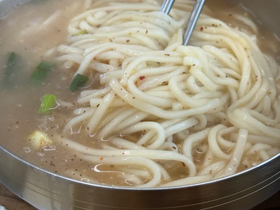 Kalguksu noodles lifted with chopsticks
