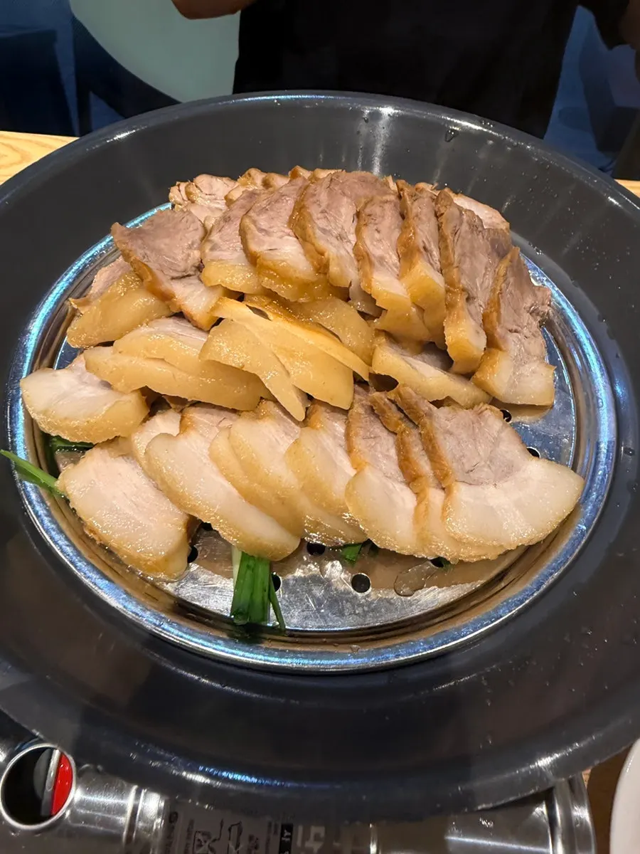 Large Sambaek bossam served on a tabletop burner