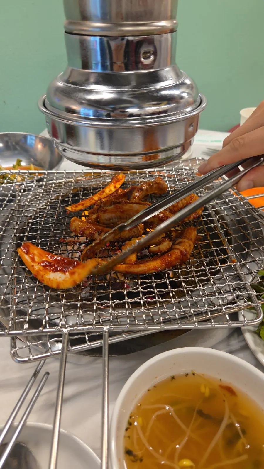 Seasoned seafood cooking over charcoal