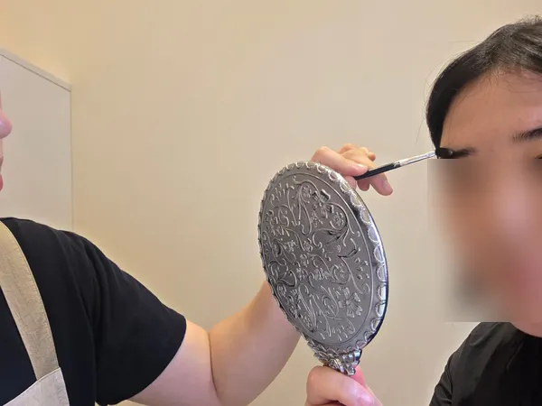Checking eyebrow condition at the consultation table