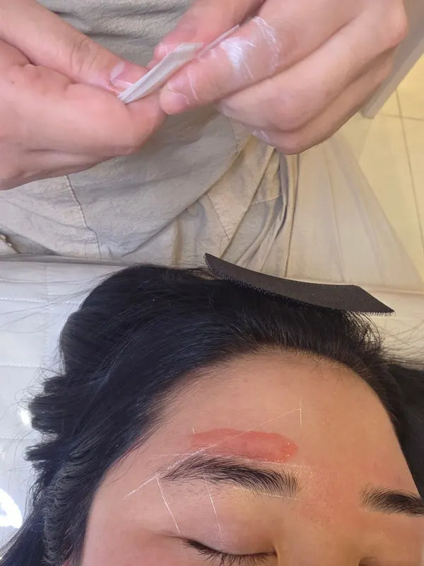 Eyebrow mapping done with white guidelines