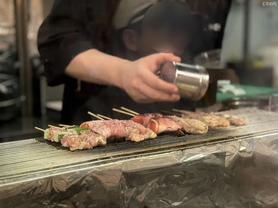 Skewers being grilled by hand
