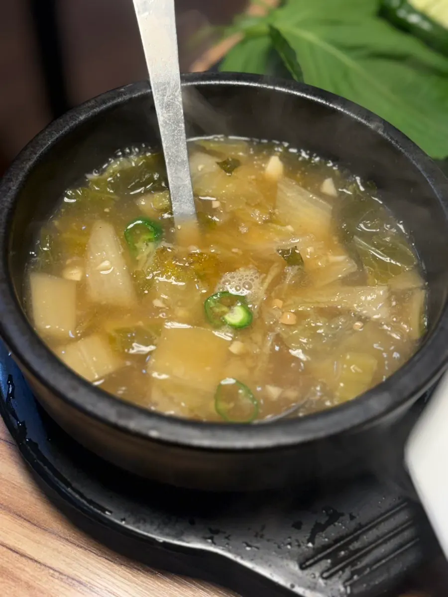 Cabbage doenjang soup served with a makgeolli order