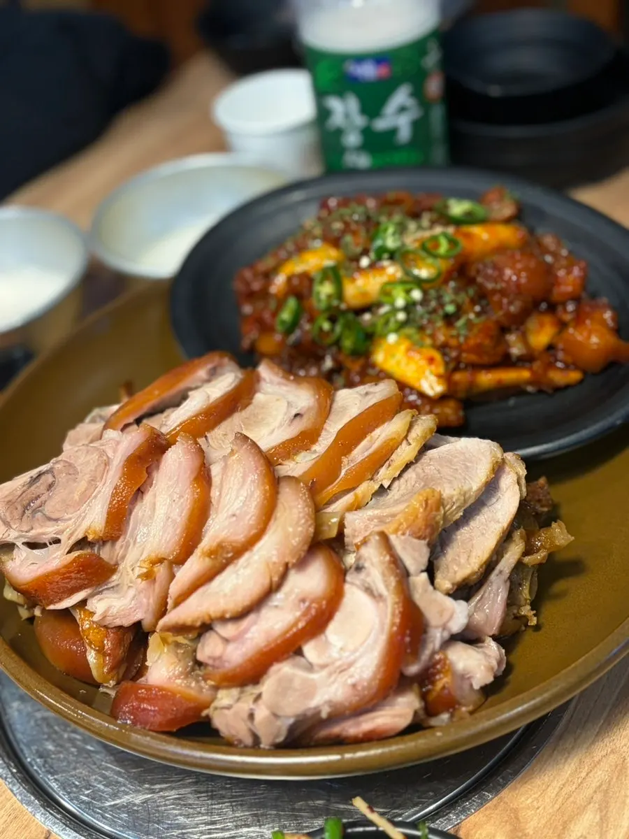 Glossy regular jokbal next to spicy jokbal, half-and-half plating