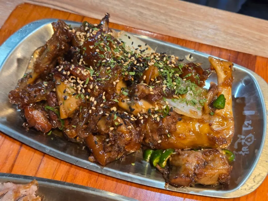 Soy garlic jokbal served with noodles