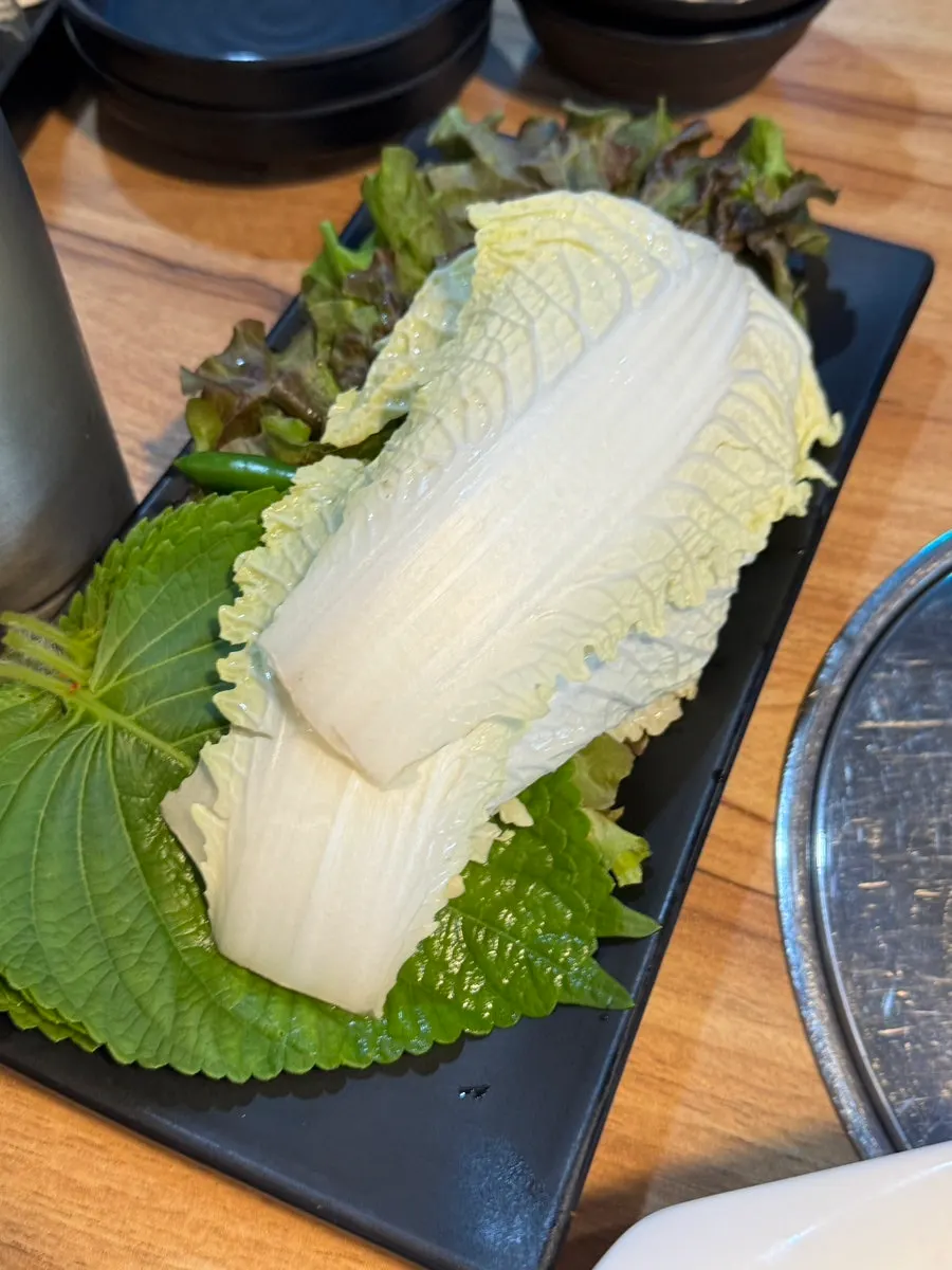 Plate of radish kimchi and chive salad side dishes