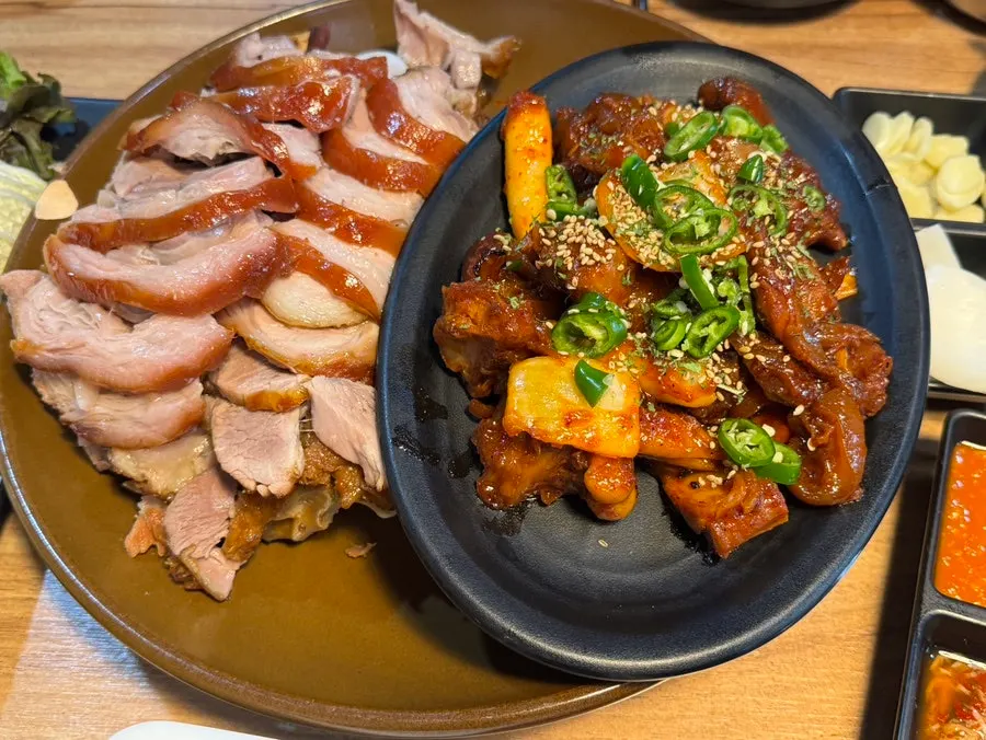 A plate of half-and-half front leg jokbal with regular and spicy sides