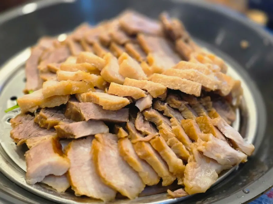 Sambaekga's bossam served on a tabletop burner