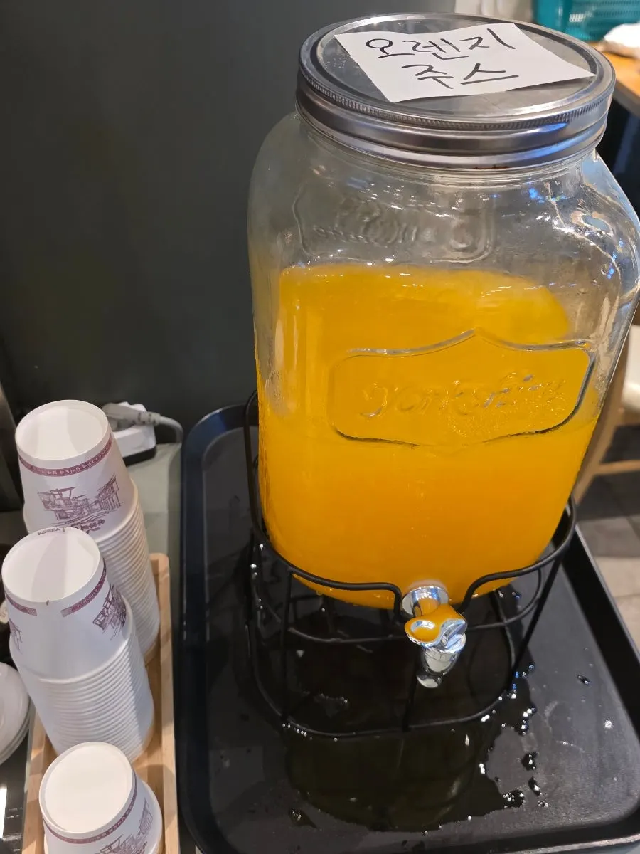 Orange juice and candy served after the meal