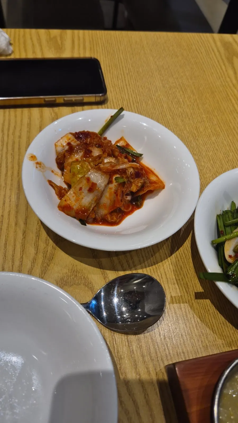 A piece of persimmon salad placed on top of bossam