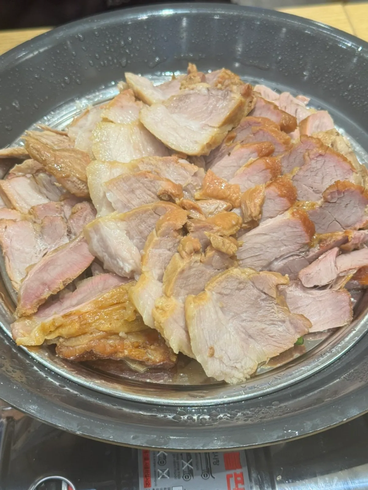 Large bossam served on a burner at Sindorim Sambaekga