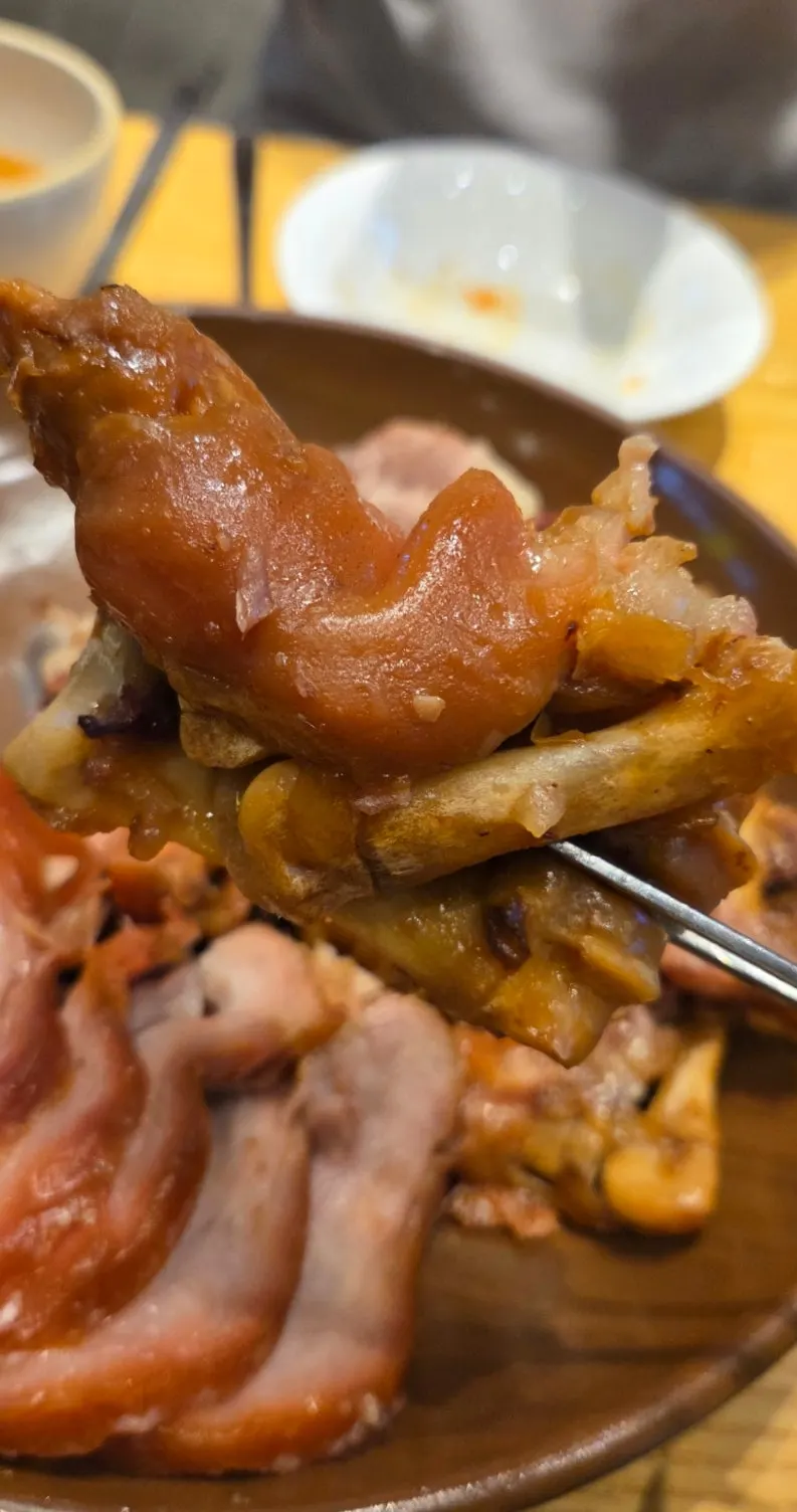 A nearly emptied jokbal plate with a soju glass