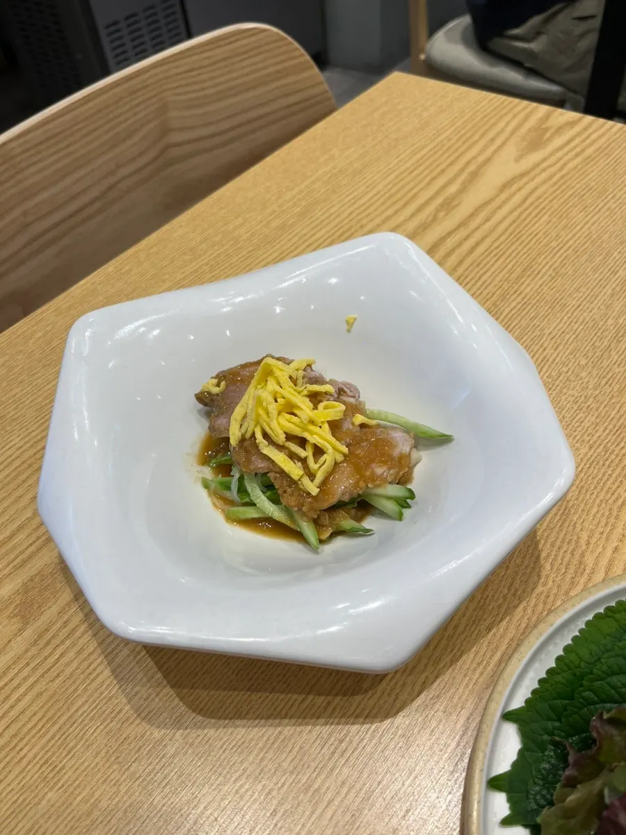 A piece of jokbal wrapped in chives