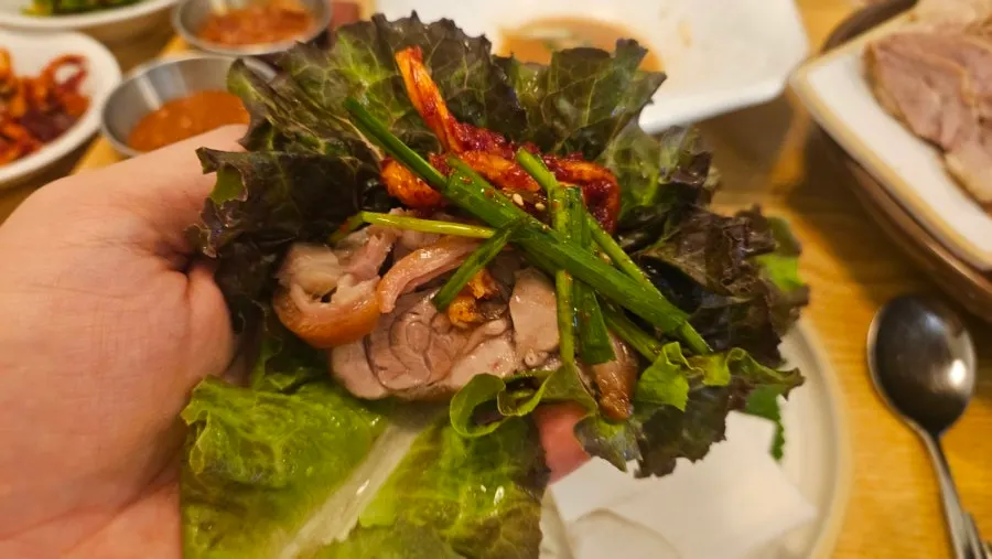 A piece of jokbal dipped in sauce