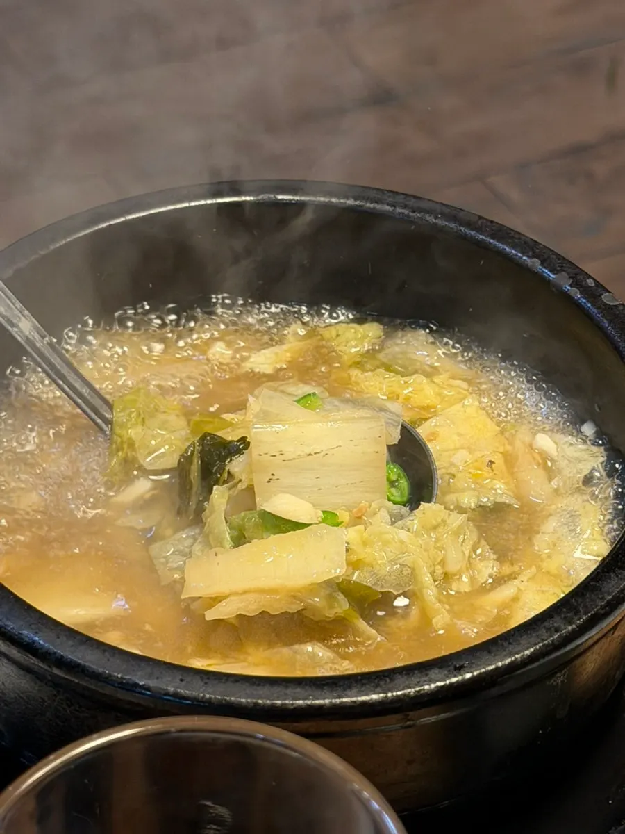 Hot cabbage soup served alongside the meal