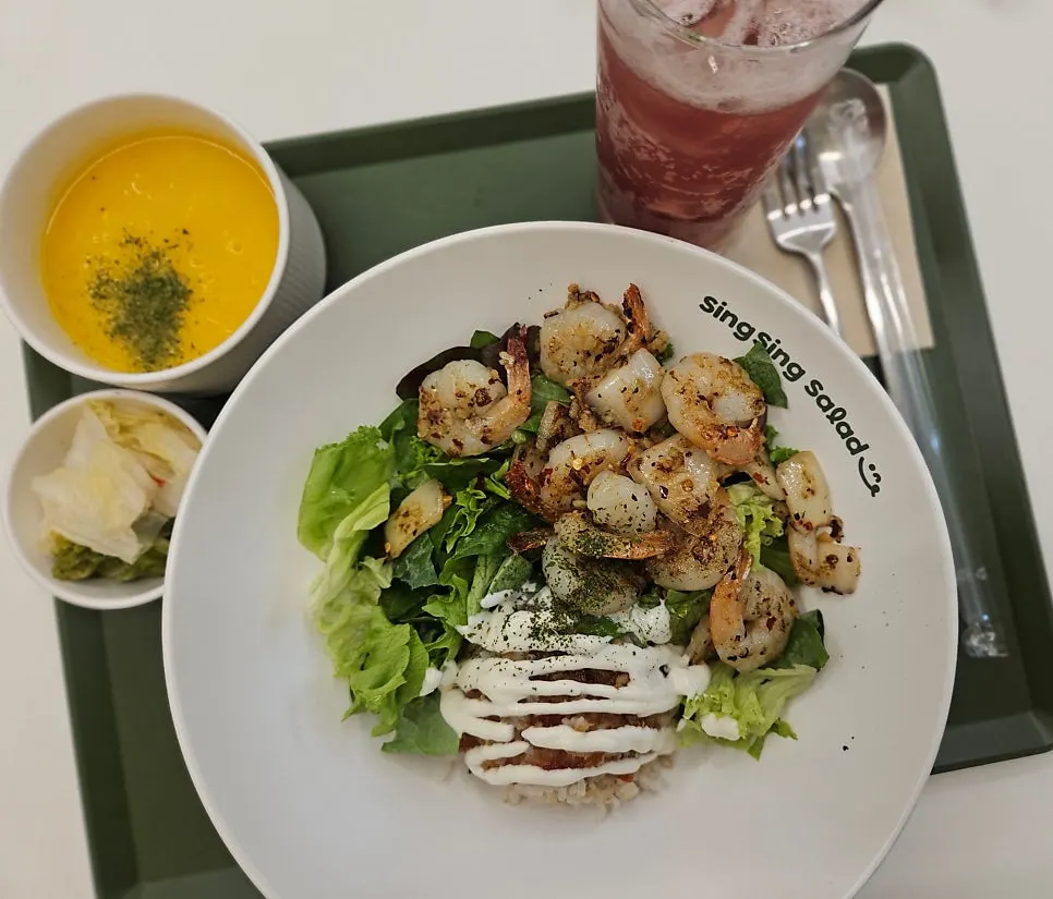 Table spread of garlic shrimp poke, pumpkin cream soup, and hibiscus ade