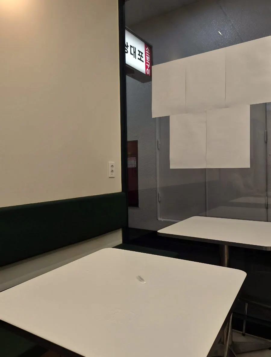 Clean white-toned seating area inside Singsing Salad Yeouido Branch