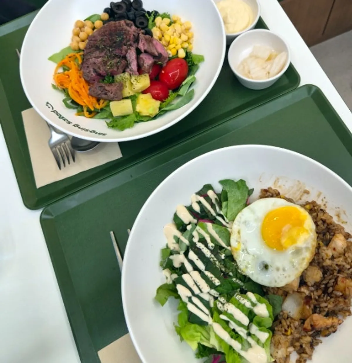 Table set for two with the chili stir-fry salad rice bowl and sous vide beef flap steak salad