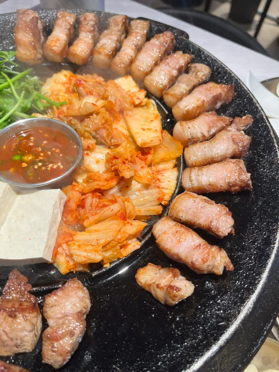 Pork belly and pork neck on a cast-iron grill