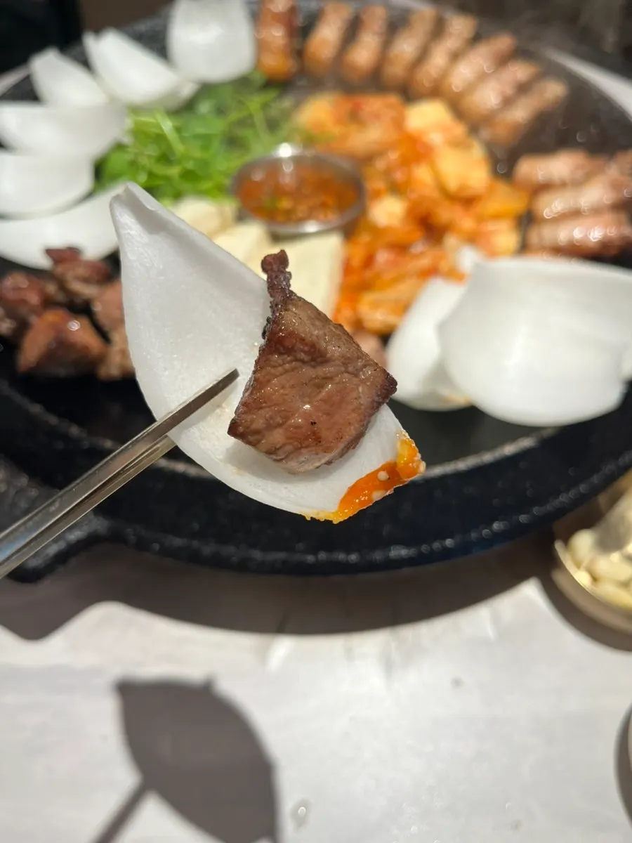 Onion wraps placed at one side of the grill