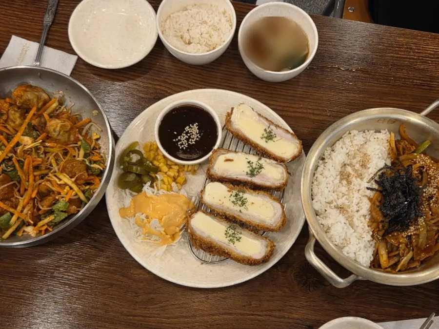 Bibim mandu, cheese donkatsu, and spicy pork rice bowl spread