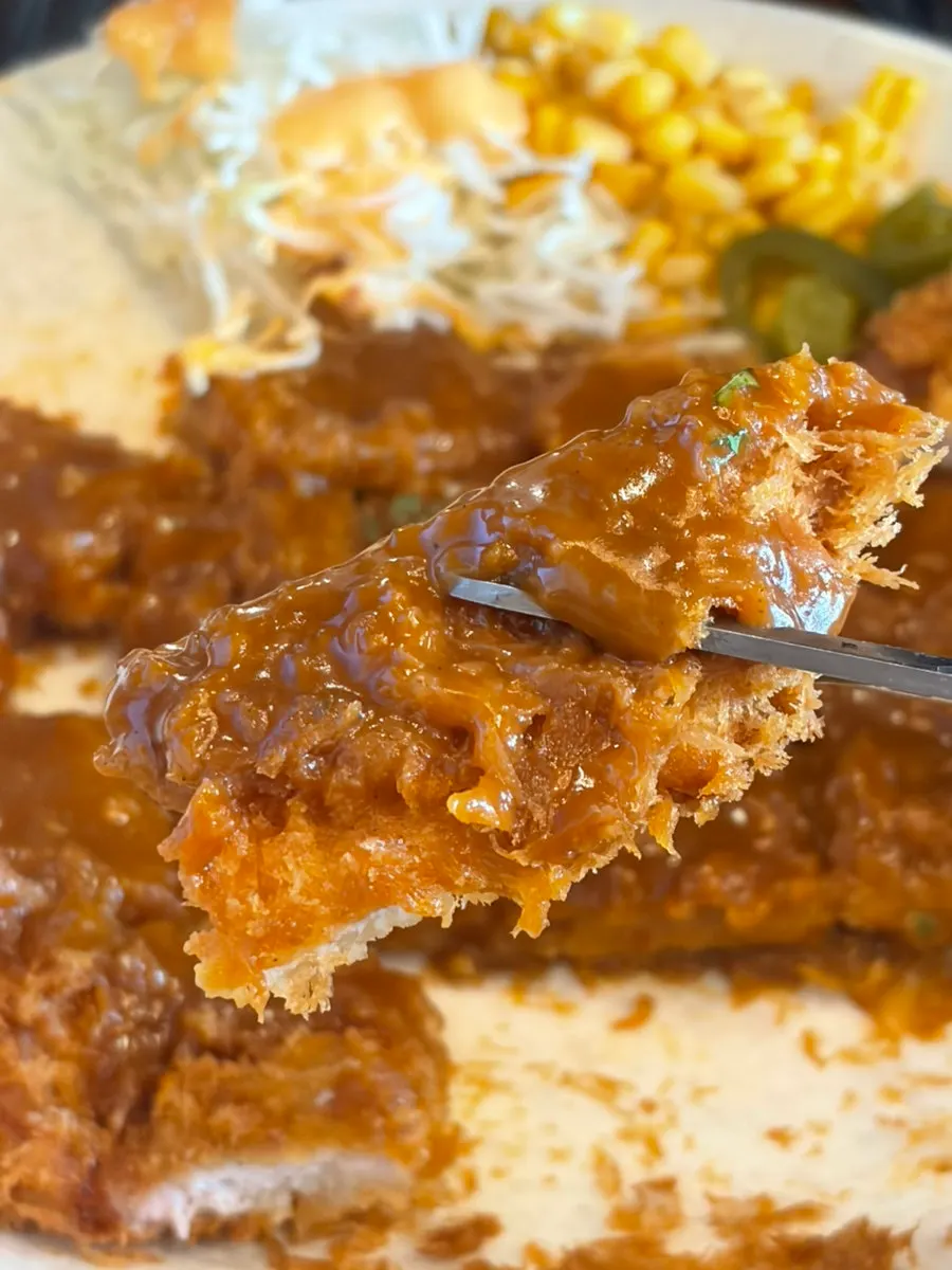 Old-style jumbo pork cutlet smothered in sauce