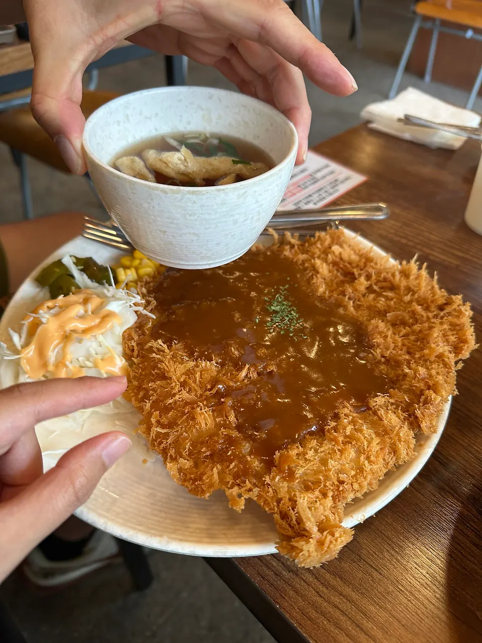 Large old-school pork cutlet filling the entire plate
