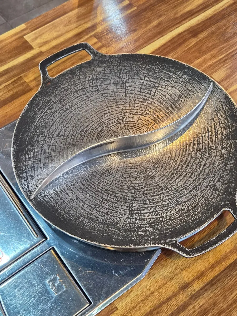 Grill divided in half with ingredients before cooking