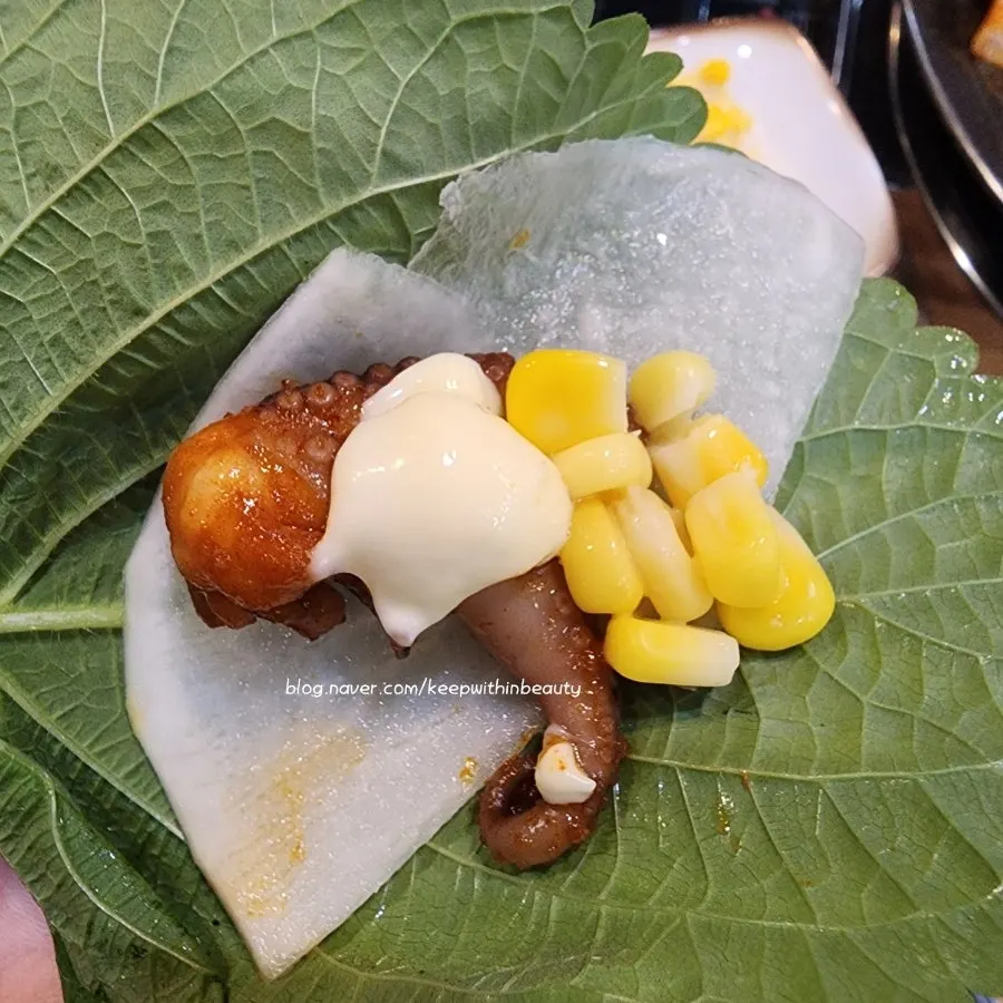 Perilla leaf wrap with jjukkumi and shaved pork belly