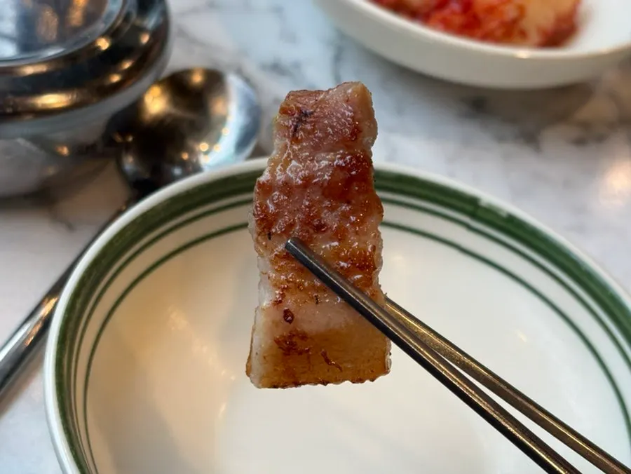 Golden-brown pork belly on the grill