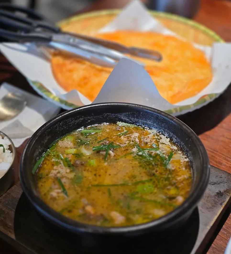 A bowl of Sinju Okmi's rich, dark sundaeguk broth