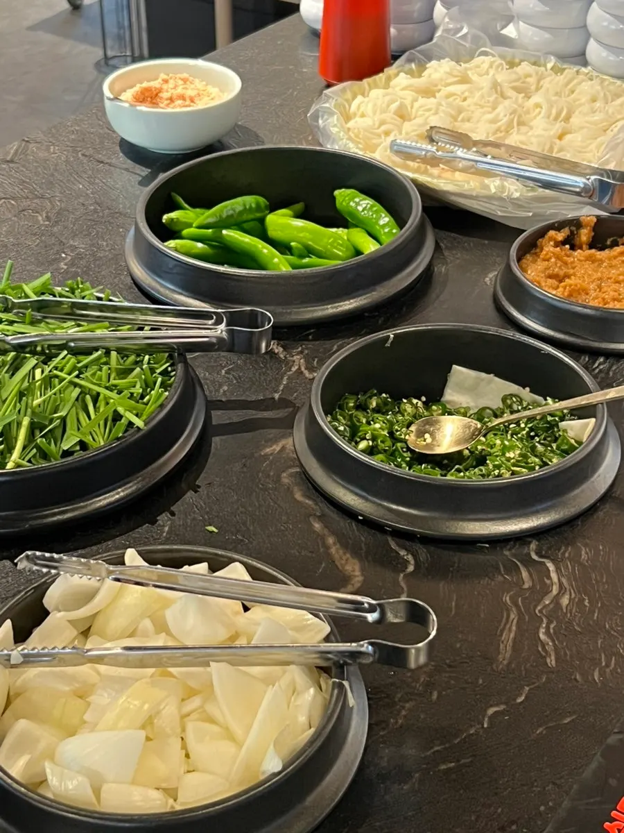 Kimchi, chives, and somyeon noodles at the self-serve bar