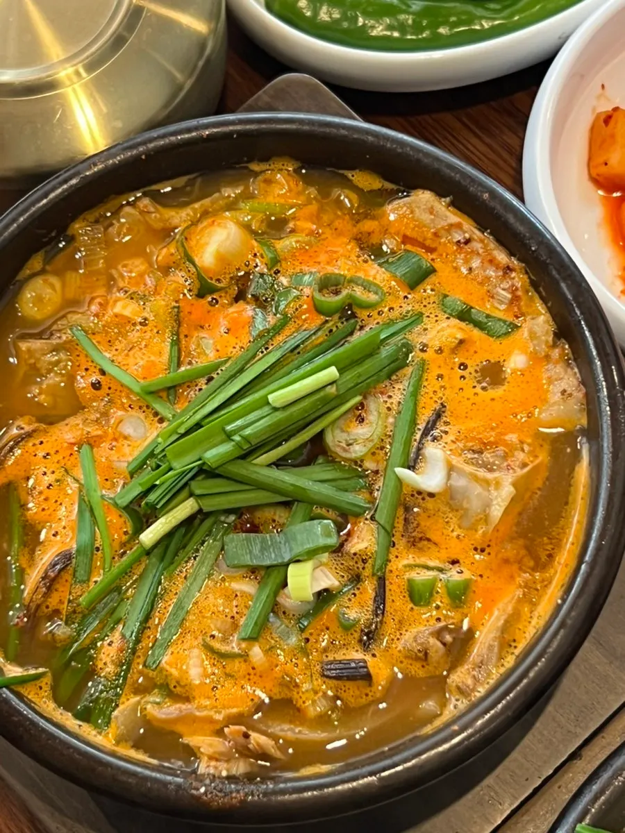 A piece of suyuk with salted shrimp sauce and ssamjang