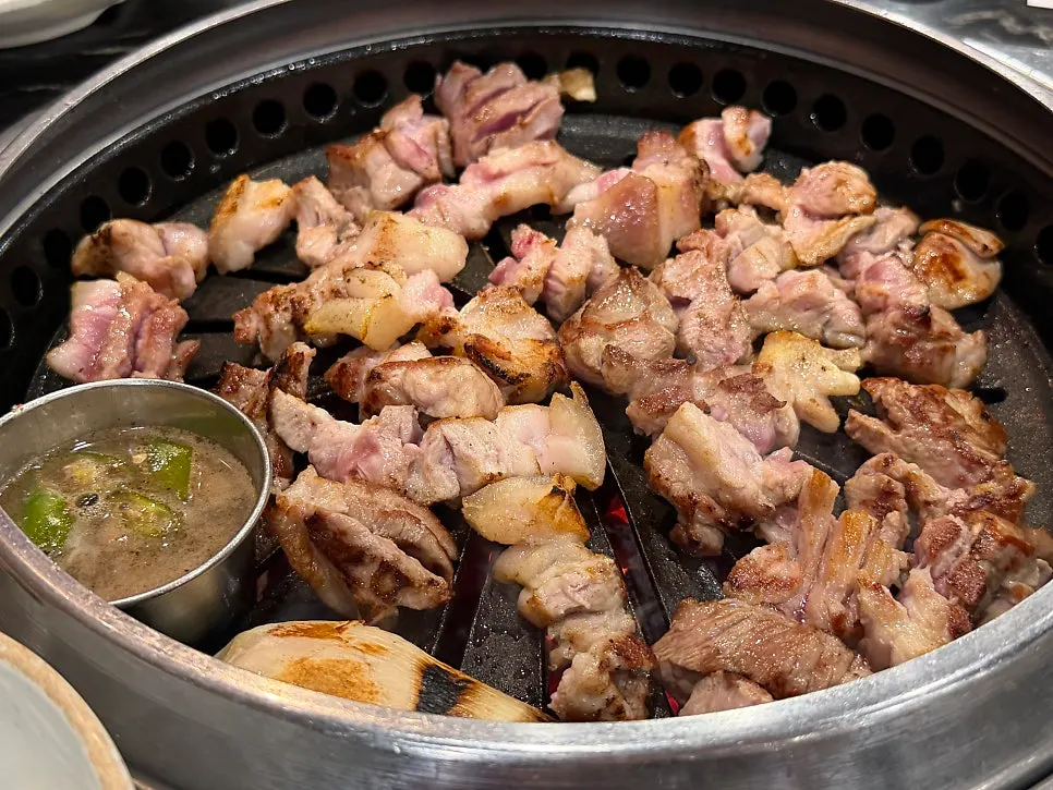 Table spread of black pork and side dishes ordered by four people