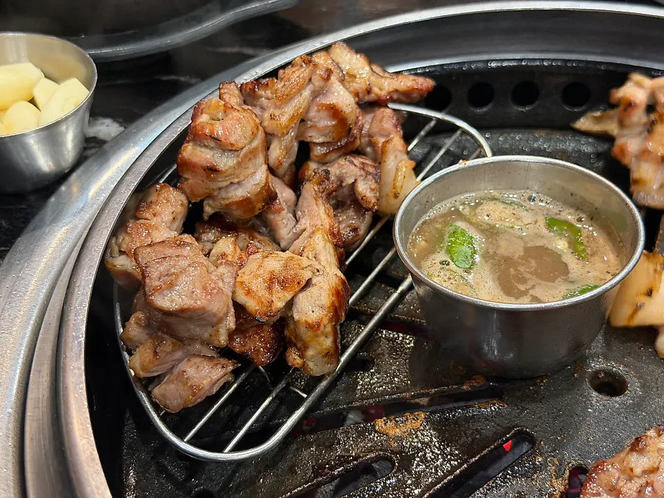 A piece of Jeju black pork grilled over charcoal
