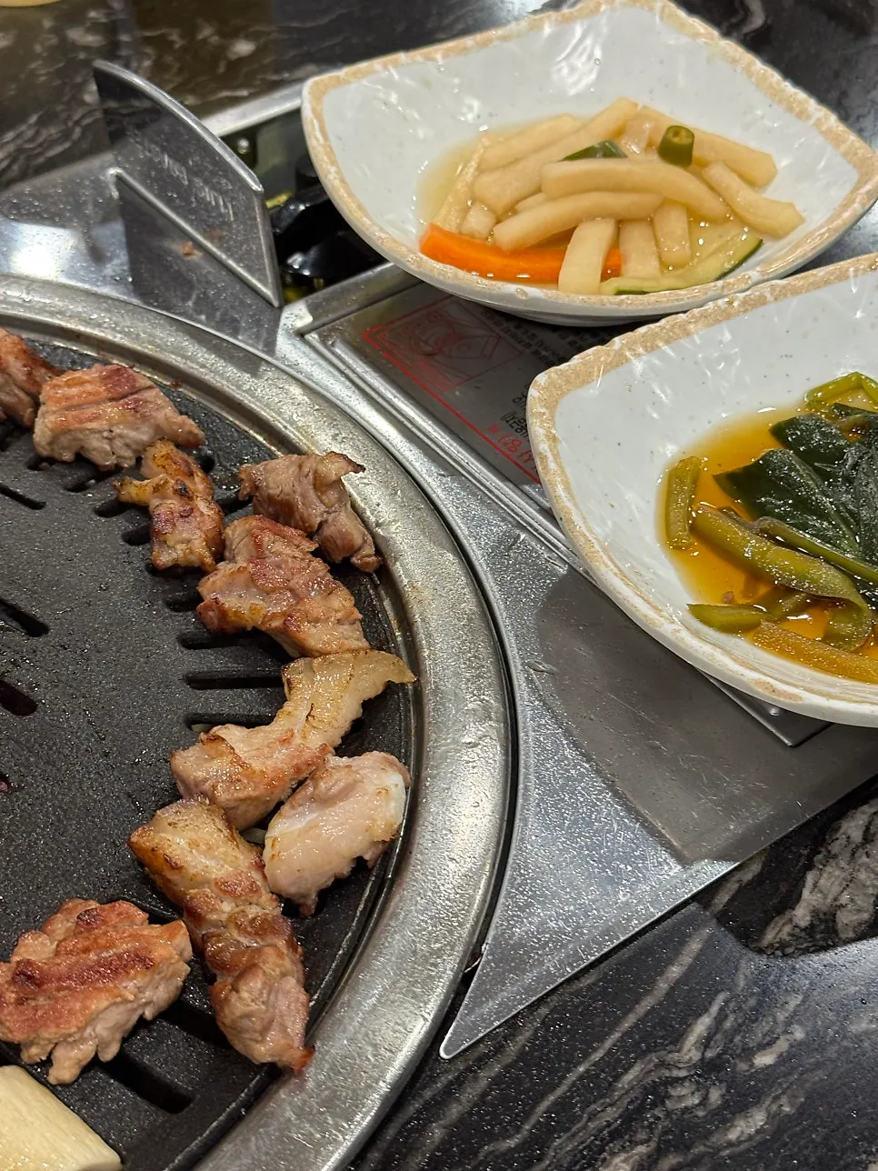 A piece of Jeju black pork dipped in myeoljeot sauce