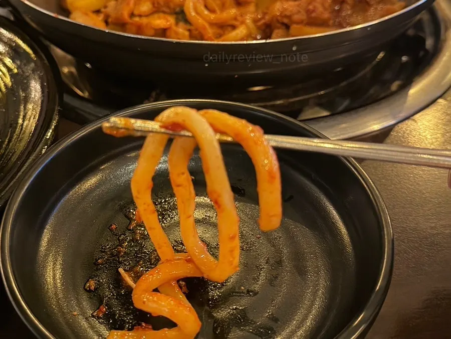 Dakgalbi cooking on the pan loaded with ingredients
