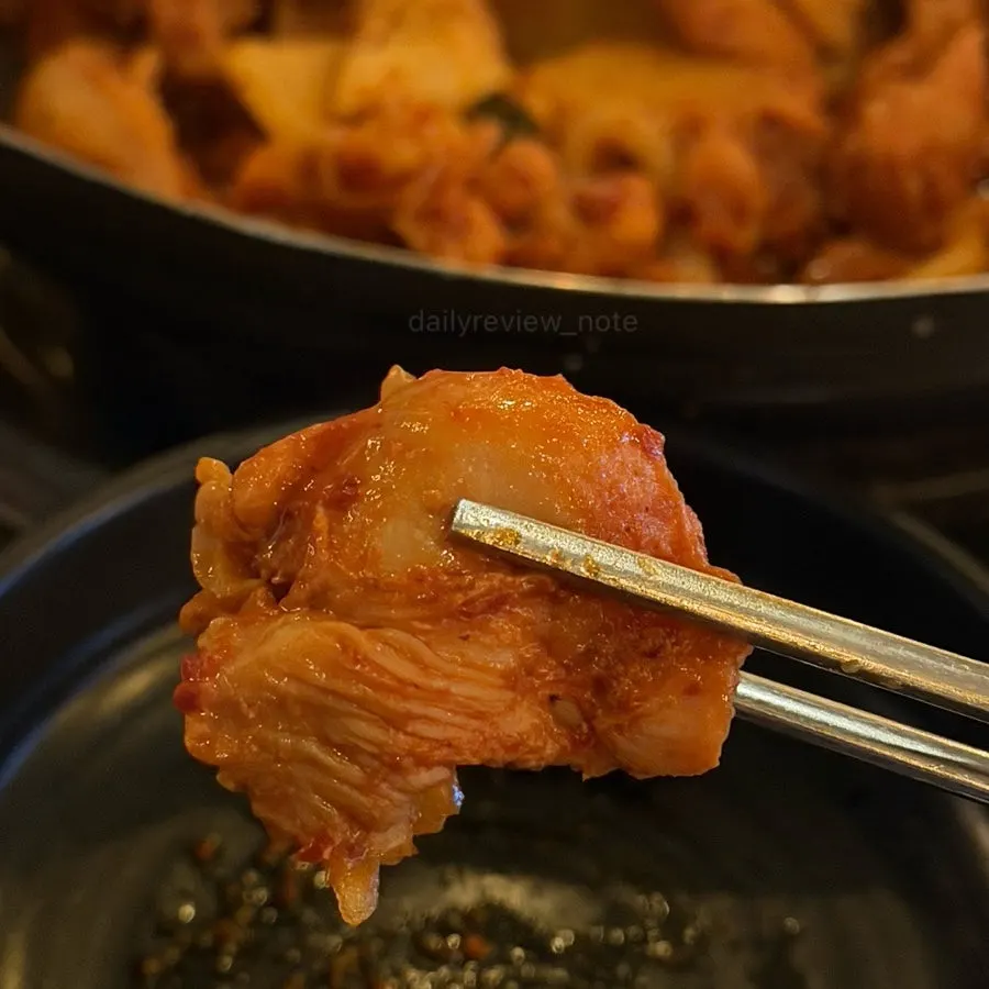 A piece of tender chicken lifted from the pan