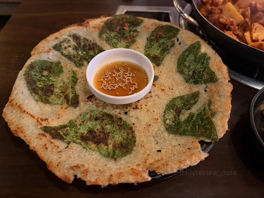 A plate filled with a large perilla-potato pancake