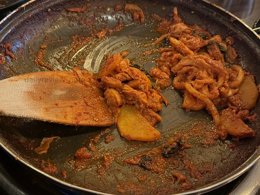 Fried rice being prepared in the pan with leftover dakgalbi