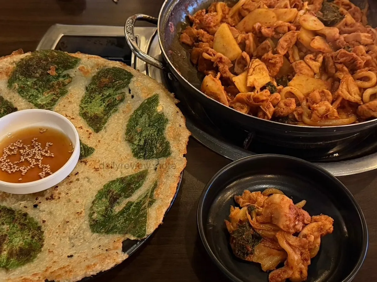 Table spread with dakgalbi, perilla-potato pancake and fried rice