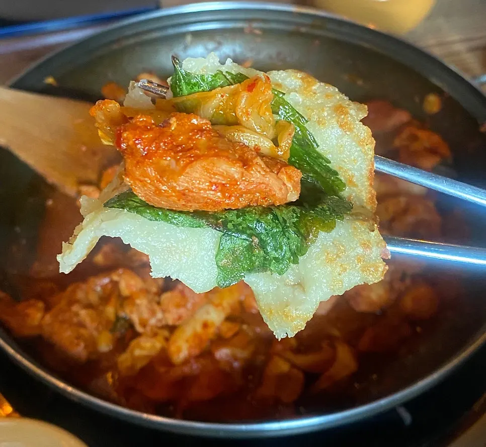 Dakgalbi placed on top of the potato pancake