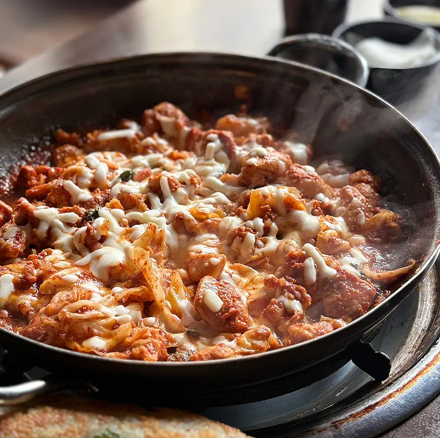 Cheese dakgalbi on the grill, spice level toned down